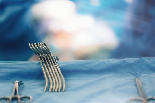 Team of surgeons in hospital operating room. Ready for cardiovascular surgery instruments for open heart microsurgery cardiac retractors, minithoracotomy retractor, needle holder, clamps and hemostat