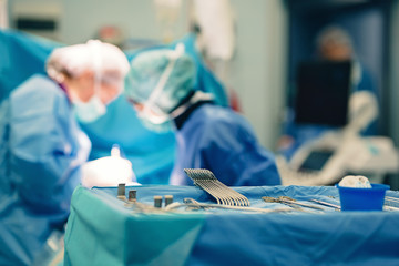 Surgical room in hospital with medical team of surgeons doing minimal invasive surgical...