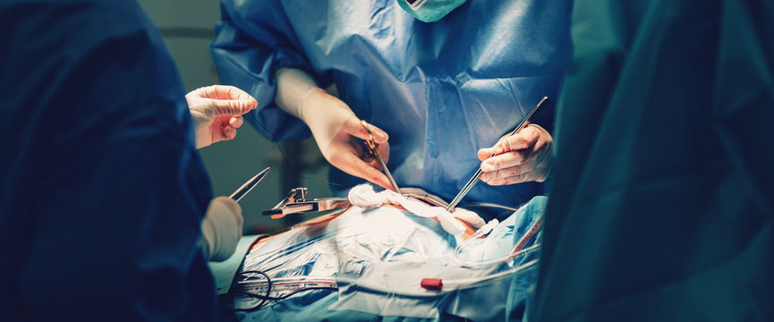 Surgical room in hospital with medical team of surgeons doing minimal invasive surgical interventions. Surgery operating room with electrocautery equipment for cardiovascular emergency surgery center