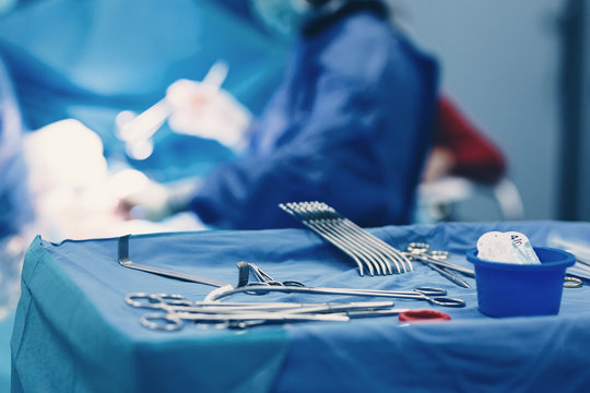 Medical team of surgeons in hospital doing minimal invasive surgical interventions. Surgery operating room with electrocautery equipment for cardiovascular emergency surgery center.