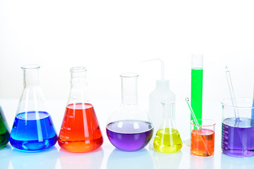 Laboratory glassware with colorful chemical reagent in research laboratory 
