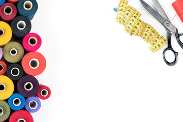 Sewing supplies thread, buttons, tape, scissors on white background. Text, cover, print, poster ready