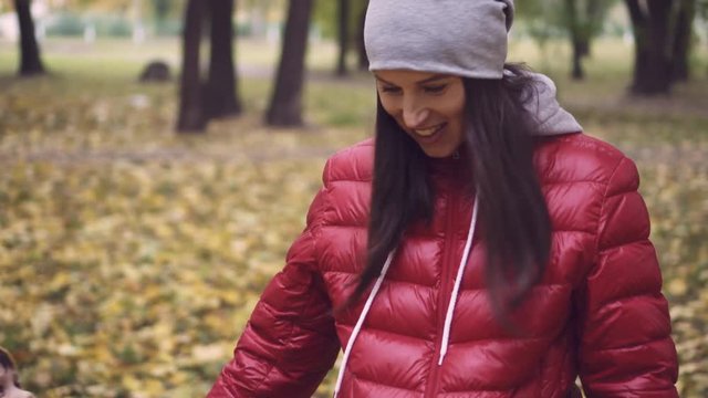 Pregnant mother and son walking in park