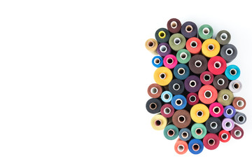 Set of coloured thread coils on white background, sewing supplies, text ready, banner, book or magazine cover, textile background