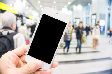 Blurred people rush hour in train station with smartphone blank screen