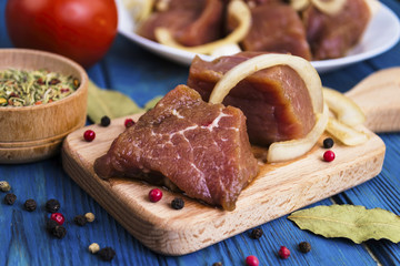 marinated pork meat for a barbecue on a wooden board