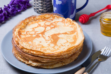 Traditional Russian pancakes with honey. Shrovetide. Maslenitsa week. Selective focus, close-up.