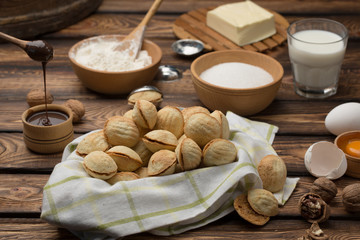 homemade cookies shaped nuts with cream boiled condensed milk on wooden table