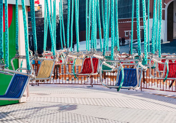 Obraz premium Empty colored seats of carousel