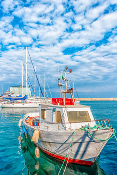 Boat moored at Monopoli port - Italy, Puglia. Adriatic sea