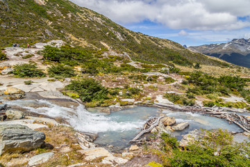 Waterfall in Laguna Esmeralda trail with  mountains and vegetation