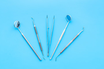 Dentist tools. Prevention of diseases of the oral cavity. Dentist appointment. Blue background top view