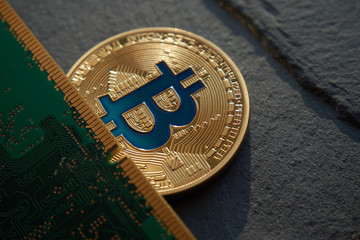 Golden bitcoin lying on the stone background