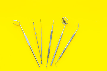 Dentist tools. Prevention of diseases of the oral cavity. Dentist appointment. Yellow background top view