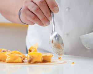 Unrecognizable cook serving dish