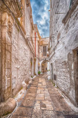 Alleyway in old white town Ostuni, Puglia, Italy