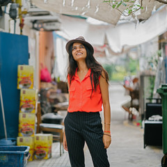 Young attractive professional Indian Asian lady standing and enjoying the backstreets of Singapore.