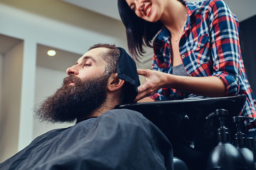 Handsome bearded man in the barbershop.