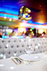 Wine-glass and white plate on the table