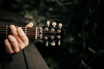 Girl with guitar in the woods