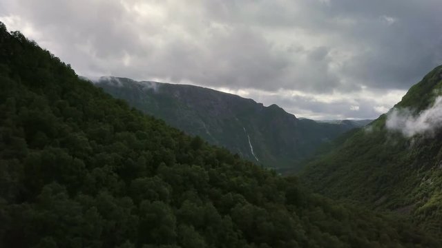 Breathtaking aerial view on the huge waterfall and the valley around it. 4k footage, bird view. Norway, Manafossen.