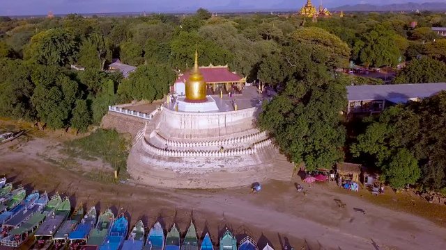 Sunset in Irrawaddy River.View river to golden Bupaya stupa. Old Bagan temples as panoramic background, Myanmar 