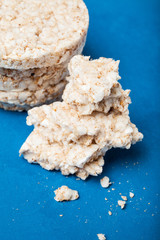 Diet gluten free bread isolated on blue background, vertical.