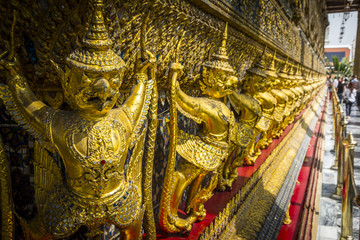 Fototapeta premium Golden Garuda sculptures vanishing point in Wat Phra Kaew temple, Bangkok.