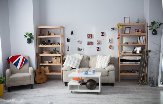 Stylish living room in white color. Wooden furniture is placed in a comfortable way.