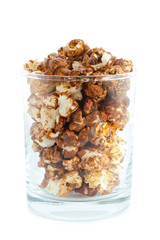 Chocolate popcorn in a transparent glass isolated on white