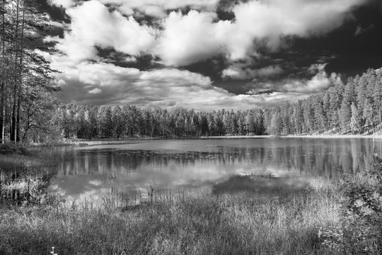 Black and white view of clouds that are reflected in the lake, Punkaharju, Lake District, Finland