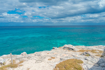 Beautiful outdoor view on the edge of the cliff Isla Mujeres Punta sun caribbean sea, with a turquoise water and gorgeous sunny day in Mexico
