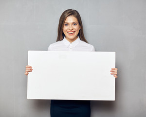 Young business woman smiling with teeth holding blank white boar
