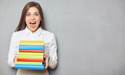 Happy student girl wearing white shirt holding books.