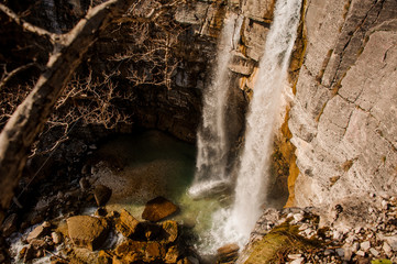 High waterfall flowing into the river in Georgia. Martvili canyon. Okatse canyon
