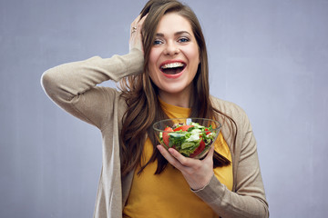 Happy casual dressed woman with long hair holding glass bowl wit