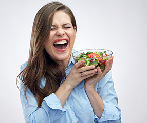 Happy woman holding salad bowl. Healthy food.