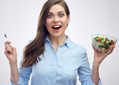 Surprising woman holding salad bowl with fork.