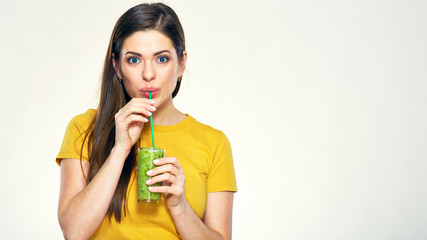 Young woman drinking green juice with straw.