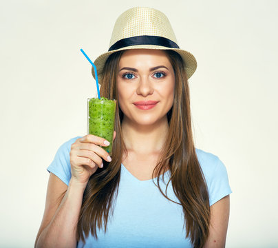 Smiling Woman Wearing Hat Holding Green Juice Glass.