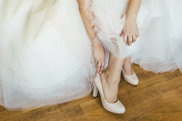 Bride wearing white wedding dress and shoes