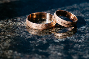Wedding rings for newlyweds on a dark background