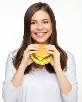 Happy girl holding fast food burger. isolated portrait on white