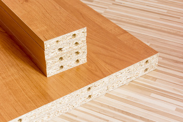 Wooden boards planked on the floor. Furniture material made of chipboard. Home assembling furniture.