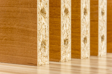 Wooden boards planked on the floor. Furniture material made of chipboard. Home assembling furniture.