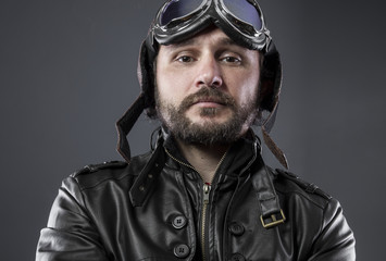 recreation of the Second World War, old airplane pilot with brown leather jacket, cap of avidor and large glasses