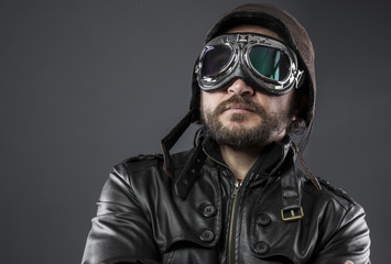 old airplane pilot with brown leather jacket, arador hat and large glasses