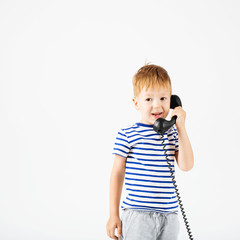 little boy with retro phone against a white