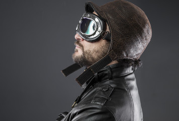 old airplane pilot with brown leather jacket, arador hat and large glasses