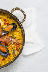 Traditional rice in paella with fish and meat.